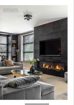 a living room filled with furniture and a flat screen tv mounted on the wall above a fire place