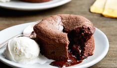 a chocolate cake with ice cream on a white plate