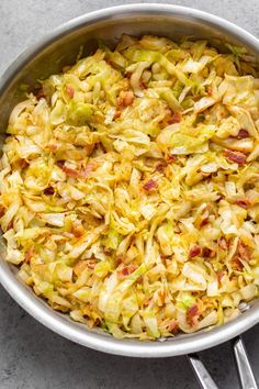 a pan filled with cabbage and bacon on top of a table