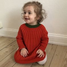 The dress is worked top down in rib pattern, resulting in a Toddler Knit Dress, Knit Dress Pattern, Pumpkin Dress, Baby Cardigan Knitting Pattern, Baby Clothes Patterns, Knitted Baby Blankets, Baby Yarn, Baby Cardigan, Knitting For Kids