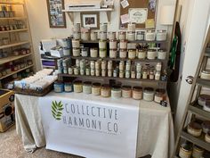 a table that has some jars on it and shelves with various items in the background