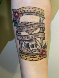 a tattoo with a skull and ribbon on it's arm that says maybe time remains, out in a jar