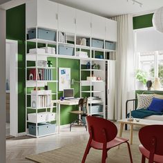 a living room filled with lots of furniture and bookshelves next to a window