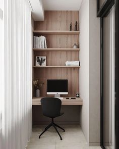 a desk with a computer on top of it in front of a bookshelf