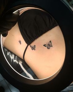 a woman's stomach with butterflies on it