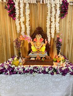 there is a small shrine with flowers on the table