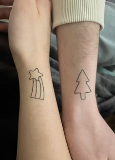 two people with matching tattoos on their arms