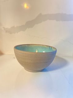 a white and blue bowl sitting on top of a table