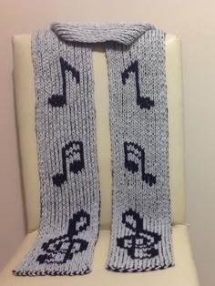 a knitted scarf with musical notes on it