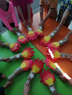 several children are making paper firecrackers out of construction paper