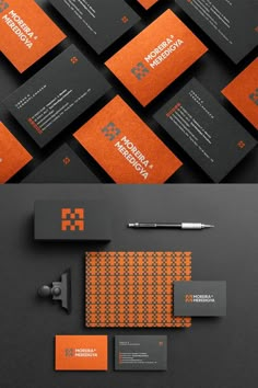 an orange and black business card is displayed on top of a gray background with the letter k