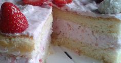 a piece of cake with white frosting and strawberries on top