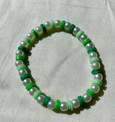 Cute green and white beaded bracelet. These are high quality handmade bracelets. They are made with an very stretchy and strong elastic string so will fit lots of sizes. They are around 6.75 inches. Please note that each braclet will have a very similar beading pattern but not exactly identical. Green Bracelets With 8mm Beads For Beach, Casual Green Beaded Bracelets With 8mm Beads, Adjustable Green Stretch Bracelet With Large Beads, Casual Green Stretch Bracelet With Large Beads, Casual Green Jewelry With Large Beads, Trendy Green Letter Beads, Green Beaded Bracelets With Letter And Round Beads, Trendy Green Spacer Beads, Green Pearl Bracelet With Colorful Beads