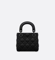 The Lady Dior bag epitomizes the House's vision of elegance and beauty. Sleek and refined, the creation is timeless. It is crafted in black ultramatte calfskin with Cannage stitching, creating the instantly recognizable quilted texture. Tonal metal D.I.O.R. charms embellish and illuminate its silhouette. Featuring a removable chain strap, the miniature Lady Dior bag can be carried by hand, on the shoulder or worn crossbody as an ideal evening wear companion.. Dior Mini Bag, Lady Dior Mini, Mini Lady Dior, Lady Dior Handbag, Womens Designer Bags, Christian Dior Couture, Dior Handbags, Lady Dior Bag, Lady Dior