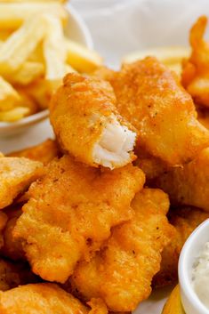 fried fish and fries with dipping sauce on the side