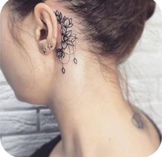 a woman with a tattoo on her neck and behind the ear