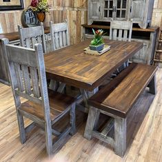 a dining room table with two benches and a potted plant on the top shelf