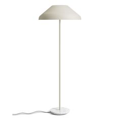 a white floor lamp with a light on the base and a cord attached to it