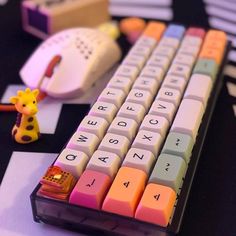 a toy giraffe is sitting next to a keyboard