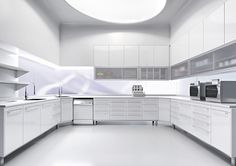 a white kitchen with lots of counter space and appliances on the counters in front of it