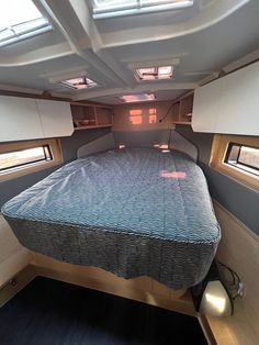 the inside of a camper with a bed and storage area on each side is shown