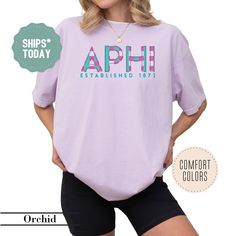 a woman wearing shorts and a t - shirt with the words aph on it