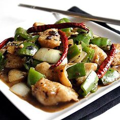 a white plate topped with chicken and veggies