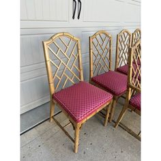 three bamboo chairs sitting next to each other in front of a garage door with hooks on the wall