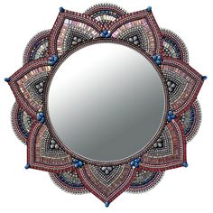 a decorative mirror is shown with beads on it