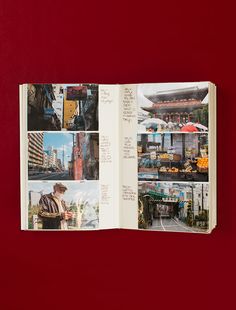 an open book with pictures of buildings and people in it on a red table top