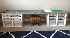 a toy table with bins on the top and some sort of storage underneath it