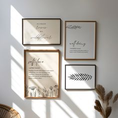 three framed art pieces hanging on the wall above a table with a potted plant