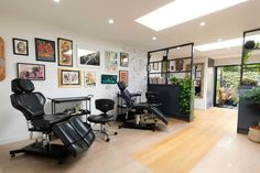 a salon with lots of chairs and pictures on the wall