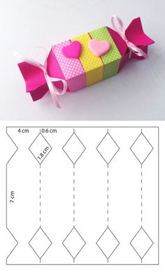 an origami box with hearts on it and the instructions for how to make it