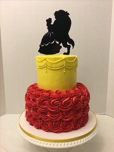 a three tiered cake with red icing and a silhouette of a man riding a horse