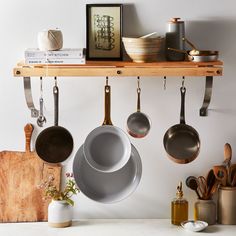 pots and pans are hanging on the wall