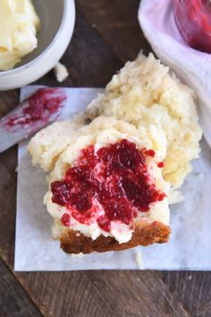 there is a piece of cake with strawberry jam on it next to some mashed potatoes