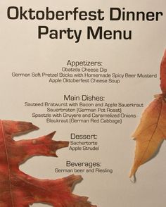 the menu for an oktoberfest dinner party is displayed with autumn leaves on it