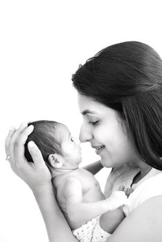 a woman holding a baby in her arms