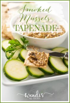 sliced cucumbers and crackers on a plate with text overlay that reads smoked mouse tapenade