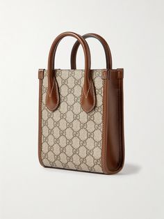 When you invest in any one of Gucci's accessories, you take home a small piece of the house's decades-spanning legacy. This messenger bag is crafted from durable coated-canvas woven with the iconic 'GG' monogram and traced along the edges by supple leather. It's sized to fit just the things you can't leave home without and is strung on a shoulder strap so you can keep your hands free. Vintage Gucci Rectangular Bag, Vintage Gucci Top Handle Bag, Timeless Monogram Canvas Bag For Formal Occasions, Classic Gucci Shoulder Bag For Shopping, Classic Gucci Rectangular Bag, Brown Timeless Monogram Canvas Bag, Timeless Brown Monogram Canvas Bag, Classic Gucci Coated Canvas Bag, Classic Gucci Bag With Top Handle