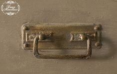 an old door handle with two knobs on the front and back of it, hanging from a wall