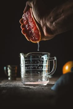 a person is squeezing something into a blender