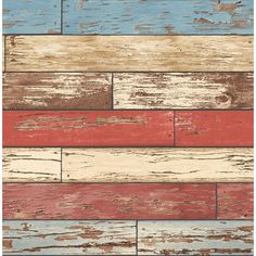 an old wood plank wall with red, white and blue painted on the boards in different colors