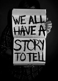 two people holding up signs that say we all have a story to tell