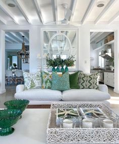 a living room filled with lots of furniture and decor on top of a white table