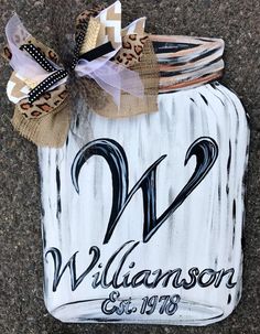 a mason jar with the number two painted on it and ribbon tied around the top