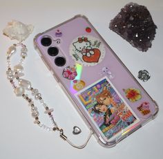 a cell phone case sitting on top of a table next to a necklace and earring