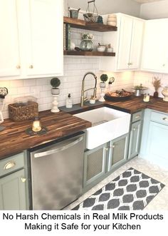 a kitchen with white cabinets and wooden counter tops, including a dishwasher in the center