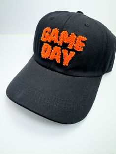 Introducing our Black/Orange Puffy Gameday Ball Cap The perfect blend of sporty style and comfort, designed to make your game day outfit stand out. Whether you're cheering from the stands or running errands, these hats are a must-have for any fan. Key Features: Classic baseball cap design with an adjustable strap for a perfect fit High-quality, durable fabric for long-lasting wear Comfortable fit for all-day wear "Game Day" letters are in a puffy design for a unique look Fast shipping from Texas Baseball Cap Design, Puffy Design, Curvy Girl Dress, Game Day Outfit, Gameday Outfit, Girls Denim, Day Outfit, Basic Outfits, Cap Design